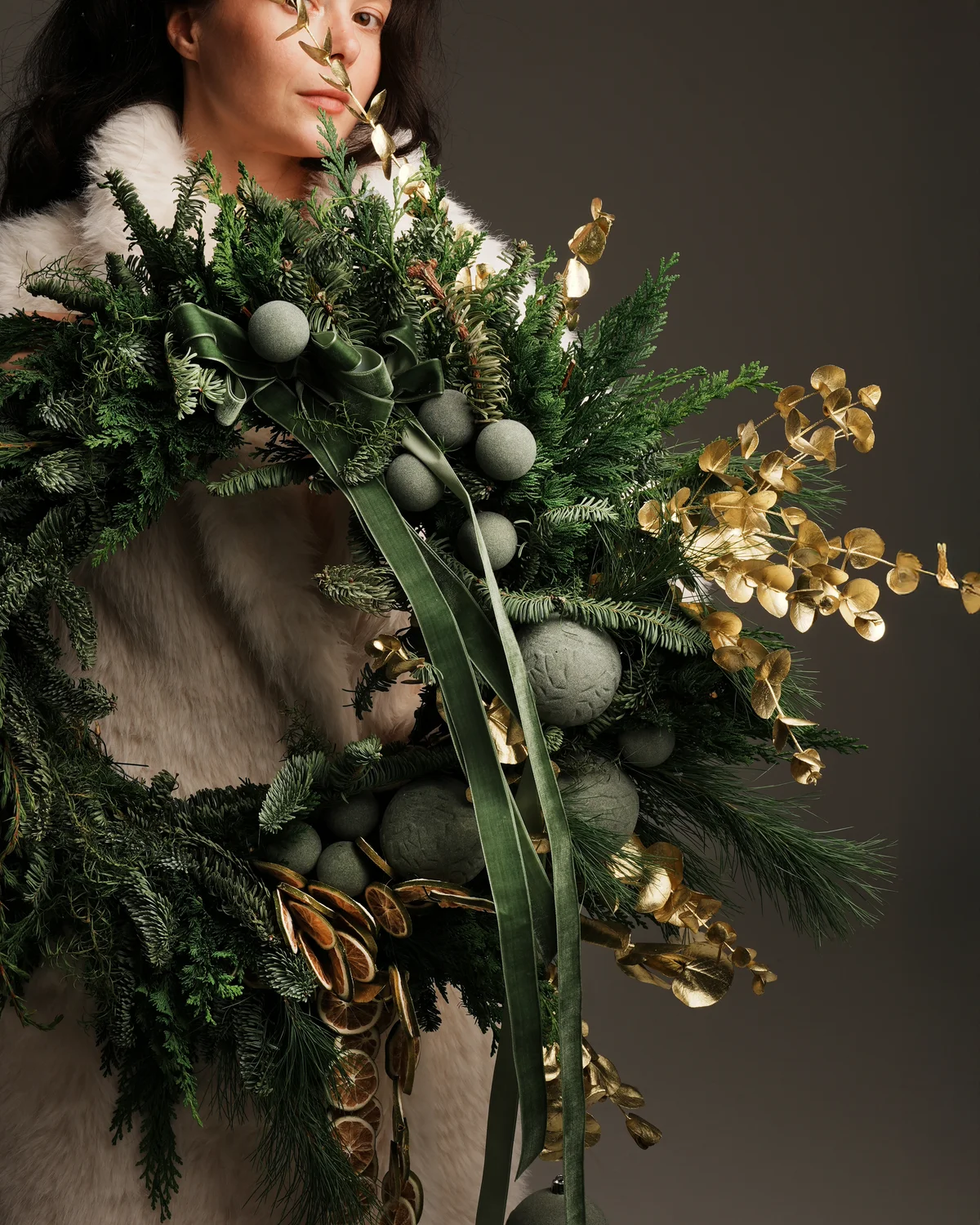 Handmade evergreen wreath with green velvet ribbons, green ornaments and gold foliage